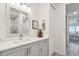 Bathroom with modern vanity, framed mirror, marble countertop, and an ensuite shower at 400 150Th Ave # 301, Madeira Beach, FL 33708