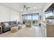 Bright living room features stylish furniture, balcony access, and contemporary decor at 400 150Th Ave # 301, Madeira Beach, FL 33708