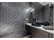 Contemporary powder room with textured walls and black vessel sink at 1000 Water St # 1703, Tampa, FL 33602