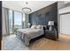 Main bedroom with wood feature wall and city view at 1000 Water St # 1703, Tampa, FL 33602