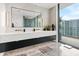 Double vanity bathroom with large mirror and city view at 1000 Water St # 1703, Tampa, FL 33602