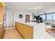 Modern kitchen with island, white countertops and light wood cabinets at 1000 Water St # 1703, Tampa, FL 33602