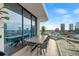 Elegant balcony with a dining table and city views at 1000 Water St # 1703, Tampa, FL 33602