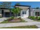 Modern home with gray and white exterior, landscaping, and walkway at 4511 24Th S Ave, St Petersburg, FL 33711