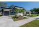 Modern home with gray and white exterior, landscaping, and a paved driveway at 4511 24Th S Ave, St Petersburg, FL 33711