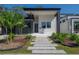 Modern home with gray and white exterior, landscaping, and walkway at 4511 24Th S Ave, St Petersburg, FL 33711