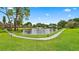 Scenic pond with a water fountain, surrounded by lush landscaping and walkways at 8174 Terrace Garden N Dr # 306, St Petersburg, FL 33709