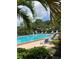 Community pool with lounge chairs and palm trees at 8174 Terrace Garden N Dr # 306, St Petersburg, FL 33709