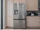 Stainless steel refrigerator in a modern kitchen with light wood cabinets at 4511 24Th S Ave, St Petersburg, FL 33711