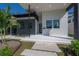Modern home's entrance with gray and white exterior, landscaping, and walkway at 4511 24Th S Ave, St Petersburg, FL 33711