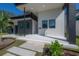 Modern home's entrance with gray and white exterior, landscaping, and walkway at 4511 24Th S Ave, St Petersburg, FL 33711