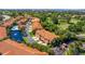 Beautiful aerial view of the community, showcasing lush landscaping, a community pool, and serene water features at 6251 Vista Verde W Dr, St Petersburg, FL 33707