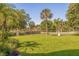 Landscaped backyard with lush greenery and a view of a canal at 6251 Vista Verde W Dr, St Petersburg, FL 33707