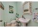 Light and airy bathroom with pedestal sink and decorative mirror at 6251 Vista Verde W Dr, St Petersburg, FL 33707