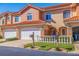 Charming townhome featuring a well-manicured lawn, white picket fence, and a two-car garage at 6251 Vista Verde W Dr, St Petersburg, FL 33707