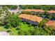Townhome with a terra cotta roof, a lush lawn, and a picturesque pond at 6251 Vista Verde W Dr, St Petersburg, FL 33707