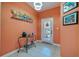 Bright foyer with a decorative table, coastal artwork, and tile flooring at 6251 Vista Verde W Dr, St Petersburg, FL 33707