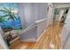 Upstairs hallway with hardwood floors and beach themed art at 6251 Vista Verde W Dr, St Petersburg, FL 33707