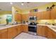 Bright kitchen with wood cabinets, stainless steel appliances, and ample counter space at 6251 Vista Verde W Dr, St Petersburg, FL 33707