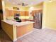 Bright kitchen with wood cabinets, stainless steel appliances, and breakfast bar at 6251 Vista Verde W Dr, St Petersburg, FL 33707