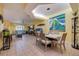 Spacious living and dining area featuring tile flooring, modern lighting, and coastal decor at 6251 Vista Verde W Dr, St Petersburg, FL 33707