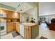Bright kitchen featuring wood cabinets, granite countertops, and views of the dining and living areas at 6365 Bahia Del Mar Blvd # 105, St Petersburg, FL 33715