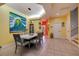 Bright dining room with large ocean-themed art and seating for six at 6251 Vista Verde W Dr, St Petersburg, FL 33707