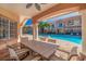 Covered patio with table and chairs overlooking the pool at 6251 Vista Verde W Dr, St Petersburg, FL 33707