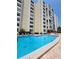 Refreshing swimming pool with surrounding lounge chairs at 851 Bayway Blvd # 205, Clearwater Beach, FL 33767