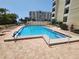 Community pool with plenty of lounge chairs at 851 Bayway Blvd # 205, Clearwater Beach, FL 33767