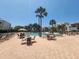 Community pool with lounge chairs and tables, ideal for relaxing at 851 Bayway Blvd # 205, Clearwater Beach, FL 33767