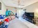 Bright bedroom with a double bed, ceiling fan, and access to a balcony at 851 Bayway Blvd # 205, Clearwater Beach, FL 33767