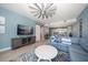 Spacious living room with large TV and sectional sofa at 300 150Th Ave # 411, Madeira Beach, FL 33708