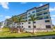 Modern building exterior with pool and palm trees at 300 150Th Ave # 411, Madeira Beach, FL 33708