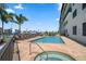 Community pool and spa with lounge chairs at 300 150Th Ave # 411, Madeira Beach, FL 33708