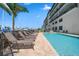 Community pool with lounge chairs and marina view at 300 150Th Ave # 411, Madeira Beach, FL 33708