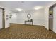 Hallway with carpet, elevator access, and a small table at 851 Bayway Blvd # 205, Clearwater Beach, FL 33767