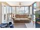 Sunroom with large windows, comfortable couch, and home gym at 851 Bayway Blvd # 205, Clearwater Beach, FL 33767