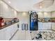 Kitchen with white cabinets, granite countertops, and black appliances at 851 Bayway Blvd # 205, Clearwater Beach, FL 33767