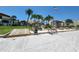 Beach access with benches and palm trees in front of condo building at 851 Bayway Blvd # 205, Clearwater Beach, FL 33767