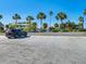Empty parking lot with one car parked and numbered spaces at 851 Bayway Blvd # 205, Clearwater Beach, FL 33767