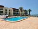 Community pool with surrounding lounge chairs at 851 Bayway Blvd # 205, Clearwater Beach, FL 33767