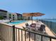 Relaxing pool with patio furniture and waterfront views at 851 Bayway Blvd # 205, Clearwater Beach, FL 33767