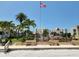 Beach access with benches and palm trees in front of condo building at 851 Bayway Blvd # 205, Clearwater Beach, FL 33767