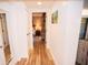 Light hallway with hardwood floors and access to bedroom at 36750 Us 19 # 2052, Palm Harbor, FL 34684