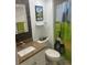 Bathroom with golf-themed shower curtain and granite countertop at 36750 Us 19 # 2052, Palm Harbor, FL 34684