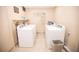 Well-lit laundry room with two sets of white washing machines and tiled floors at 36750 Us 19 # 2052, Palm Harbor, FL 34684