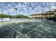 Well-maintained tennis courts with a view of the clubhouse and professional signage at 36750 Us 19 # 2052, Palm Harbor, FL 34684