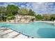 Large resort-style pool with a waterfall feature at 36750 Us 19 # 2052, Palm Harbor, FL 34684