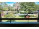 Tranquil view of lush landscaping, trees, and parking from condo balcony at 36750 Us 19 # 2052, Palm Harbor, FL 34684